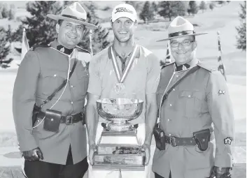  ?? [SUBMITTED] ?? Elmira’s Garrett Rank, flanked by two RCMP officers, celebrates his third Canadian Mid-Amateur tournament win in Quebec on the weekend.