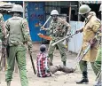  ??  ?? Anti-riot policemen stand over a floored protester amid angry demonstrat­ions, top