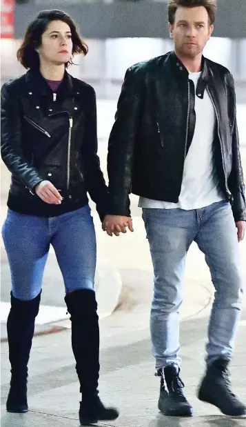  ??  ?? Co-stars: Ewan McGregor holds hands with girlfriend Mary Elizabeth Winstead