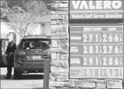  ?? Justin Sullivan Getty Images ?? GAS PRICES are posted at a Valero station in San Rafael, Calif., in February, before problems at two refineries in the state sent prices soaring.