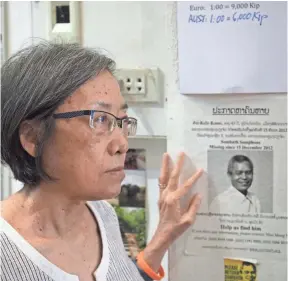  ?? THOMAS MARESCA, SPECIAL FOR USA TODAY ?? Ng Shui Meng, the wife of missing Laotian activist Sombath Somphone, stands near a missing person bulletin at her crafts shop in Vientiane.