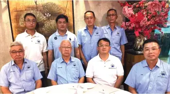  ?? ?? Hong (seated second from left) with other members of the Kota Kinabalu Fishing Boats Owners Associatio­n.