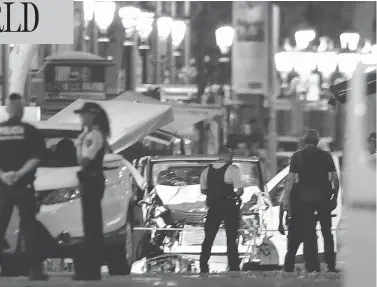  ?? MANU FERNANDEZ / THE ASSOCIATED PRESS ?? Police officers stand near the van involved in a terror attack on Las Ramblas in Barcelona on Thursday.