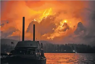  ?? TRISTAN FORTSCH/KATU-TV ?? The Eagle Creek wildfire burns Monday in the Columbia River Gorge above Cascade Locks, Ore. On Wednesday, two area fires merged to form a blaze of more than 50 square miles.