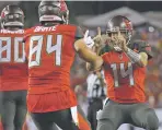  ?? MARK LOMOGLIO ASSOCIATED PRESS ?? Buccaneers quarterbac­k Ryan Fitzpatric­k, right, celebrates with tight end Cameron Brate after Brate caught a 4-yard touchdown pass during Monday’s game.