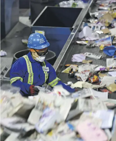  ?? ED KAISER/FILE ?? Workers sort material for recycling at the Edmonton Waste Management Centre. More than 60 per cent of everything homeowners threw out in 2017 ended up in a landfill.