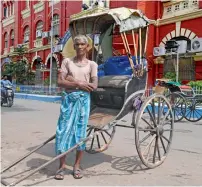  ?? AFP ?? Mohammad Ashgar stands next to his rickshaw in Kolkata. —