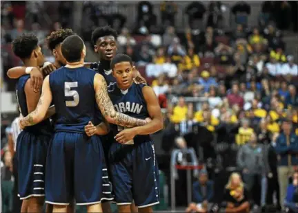  ?? ERIC BONZAR — THE MORNING JOURNAL ?? The Lorain Titans console each other as their quest for a state championsh­ip came to an end on March 23 against Cincinnati Moeller.