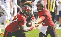  ?? MIKE EHRMANN/ GETTY IMAGES ?? Tom Brady of the Tampa Bay Buccaneers hands off to Ronald Jones at Raymond James Stadium during Sunday's 26-12 victory over the Minnesota Vikings in Tampa, Florida.