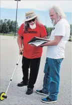  ?? PAUL FORSYTH TORSTAR ?? Day of 1,000 Musicians co-organizers Paul Lemire and John Fillion measure out the parking lot of the Gale Centre in Niagara Falls, where the event will take place on July 20.