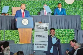  ?? STEVE HELBER/AP PHOTO ?? Virginia Del. Ibraheem Samirah, D-Fairfax, yells as he interrupts President Donald Trump’s addresses Tuesday in Jamestown, Va.