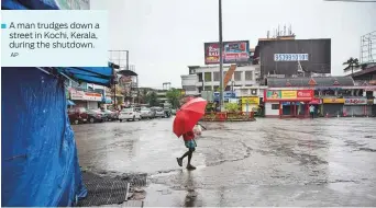  ?? AP ?? A man trudges down a ■ street in Kochi, Kerala, during the shutdown.