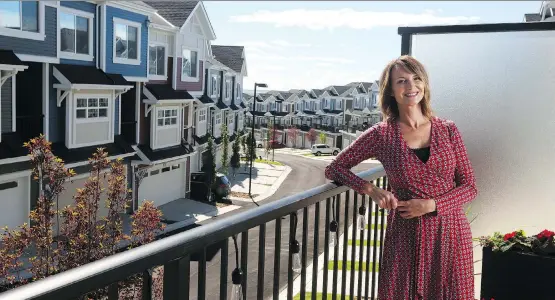  ?? CHRISTINA RYAN ?? “Everything is literally walking distance from my townhouse,” says Sunday Wihnon, on the balcony of her new home at Carnaby Heights in Nolan Hill.