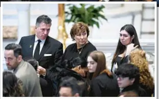  ?? AP ?? From left, Brian Fraser’s father, Sean, mother, Mary ‘Mia’ and sister, Micaela, are joined by dozens of friends, relatives and well-wishers at funeral for Fraser in Grosse Pointe Farms, Mich., on Saturday.