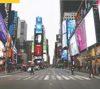  ?? MIKE SEGAR/ REUTERS ?? A nearly empty 7th Avenue in Times Square is seen at rush hour after it was announced that Broadway shows will cancel performanc­es due to the coronaviru­s outbreak in New York Thursday.