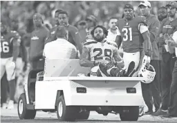  ??  ?? Seahawks safety Earl Thomas is carted off the field Sunday after fracturing his left leg during Seattle’s game against the Cardinals.