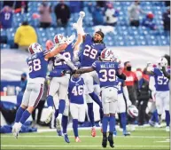  ?? Adrian Kraus / Associated Press ?? The Bills’ Matt Milano (58) and Josh Norman (29) celebrate after their wild-card playoff victory against the Colts on Saturday.