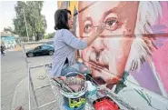  ?? ?? Iraqi artist Wijdan al-Majed draws a mural in Baghdad, on April 26.