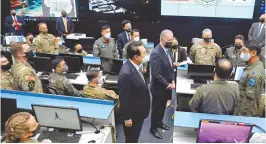  ?? AP-Yonhap ?? President Yoon Suk-yeol and U.S. President Joe Biden meet with Korean and U.S. troops at the Korean Air and Space Operations Center at Osan Air Base in Pyeongtaek, Gyeonggi Province, Sunday.