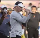  ?? ?? USC head coach Lincoln Riley signals to his team during the Trojans' 52-42 loss to Washington at the Coliseum on Saturday night.