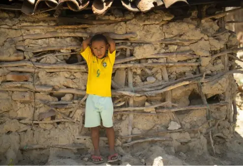  ?? AP Photo/Andre Penner ?? A boy wearing a Brazilian national team soccer jersey stands outside his home at the Campinhos community of Itinga, Minas Gerais state, Brazil in October 2022