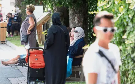  ?? — AFP ?? In plain sight: A woman wearing a burqa at a park in Zell am See which is a popular destinatio­n among tourists from Arab countries.