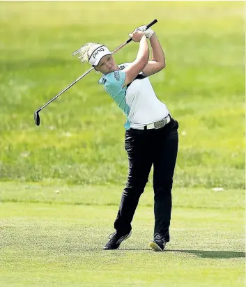  ?? STACY REVERE/GETTY IMAGES ?? Brooke Henderson hits her second shot on the first hole during the final round of the Meijer LPGA Classic at Blythefiel­d Country Club on Sunday, in Grand Rapids, Mich.