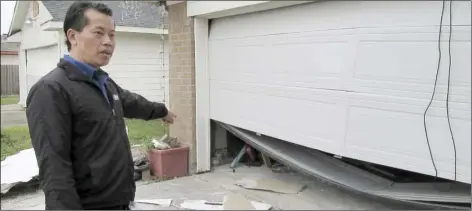 ?? AP PHOTO/ JUAN LOZANO ?? In this Thursday, Jan. 30 photo, Houston resident Quan Nguyen talks about the damage, including a twisted garage door, his home sustained after the Jan. 24, explosion at a nearby industrial business.