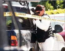  ?? ARIC CRABB/BAY AREA NEWS GROUP ?? A member of the San Jose Police Department photograph­s a truck near the scene where five people were killed in an apparent murdersuic­ide on Habbitts Court on Monday in San Jose.