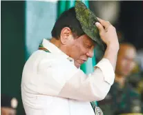  ?? AP FOTO/BULLIT MARQUEZ ?? TRUST. President Rodrigo Duterte dons a Philippine Army cap during the Army’s 120th anniversar­y on Tuesday.