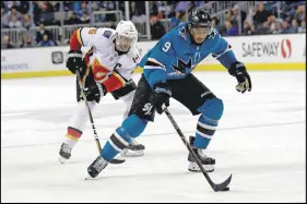  ?? AP PHOTO ?? San Jose Sharks’ Evander Kane skates in front of Calgary Flames’ Mark Giordano during the second period of an NHL hockey game in San Jose, Calif.