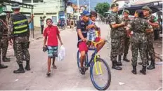  ?? Washington Post ?? ■ Soldiers sent to fight crime in Rio de Janeiro’s favelas, including Vila Kennedy, seen on March 17.