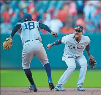  ?? NICK WASS/AP PHOTO ?? Didi Gregorius (18) and Starlin Castro celebrate after the Yankees defeated the Baltimore Orioles 7-4 on Monday afternoon at Camden Yards. Both players hit two-run homers to help New York overcome an early 3-0 deficit as the two rivals began a key...