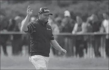  ?? The Associated Press ?? RECORD LOW: Branden Grace waves as he makes his way along the 18th fairway during the third round of the British Open Saturday. The South African set a major-championsh­ip scoring record with a 62 at Royal Birkdale in Southport, England.