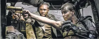  ?? JASIN BOLAND, WARNER BROS. PICTURES ?? TomHardy and Charlize Theron in a scene from MadMax: Fury Road.