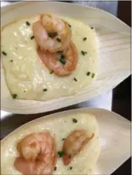  ?? JANET PODOLAK — THE NEWS-HERALD ?? Cheddar-spiked grits topped with shrimp sauteed in white wine with bacon, mushrooms and scallions is typical of the gourmet touch being given to comfort food on the new Molinari’s menu.