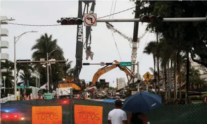  ?? Photograph: Shannon Stapleton/Reuters ?? On Monday, lightning forced crews to pause the search for victims and a garage area in the rubble filled with water, officials said.