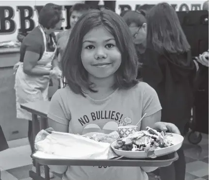  ?? JOSH HEALEY ?? A Hebbville Academy student with a tray of food from the school’s newly-launched salad bar.