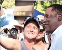  ??  ?? Larry Elder, candidate for governor takes a selfie with a supporter after a rally at Durham Community Park in Durham on Sunday.