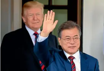  ?? AP ?? South Korean President Moon Jae-in waves as he is welcomed by President Donald Trump to the White House in Washington, yesterday.