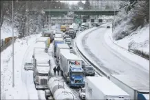  ?? Dave Killen / The Oregonian photo via AP ?? The backup of cars and trucks stuck on Interstate 84 is seen from the Blumenauer Bicycle and Pedestrian Bridge in Northeast Portland, Ore. on Thursday. Nearly a foot of snow fell in Portland on Wednesday.