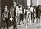  ?? Steve Gonzales / Staff photograph­er ?? Area residents wait in long lines to receive their COVID-19 vaccines on Jan. 9 at Minute Maid Park.