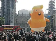  ??  ?? A six-metre-tall cartoon baby blimp of U.S. President Donald Trump is flown at a rally protesting his visit, at London’s Parliament Square on Friday.