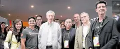  ??  ?? Singapore Prime Minister Lee Hsien Loong, together with UnionBank president and CEO Edwin Bautista and vice chair Justo Ortiz, as he made a stop at the UnionBank exhibition—the first booth he visited at the Singapore Fintech Festival in 2019.