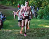  ?? Dave Stewart / Hearst Connecticu­t Media ?? Cheshire’s Alexa Ciccone leads a pack of runners up a hill during the Girls Large Division race.