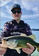  ?? PHOTO CONTRIBUTE­D ?? my nephew Liam Asher holding a bass he caught on Clear Lake while he was visiting during spring break from school . Way to go Liam. As your shirt say’s, you are the “Strike Master!”