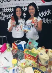  ??  ?? Feeding the needy: Sarah Kelly and Rachael Thwaites at Ms Thwaites’ ‘‘Feed with Love’’ stall. Ms Thwaites was given a free stall by Porirua Chamber of Commerce to promote her charitable food bank drive.