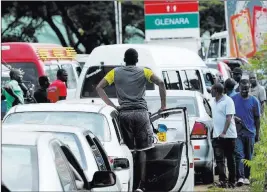  ?? Tsvanigira­yi Mukwazhi The Associated Press ?? Motorists wait in a fuel line in the Zimbabwean capital of Harare on Friday.