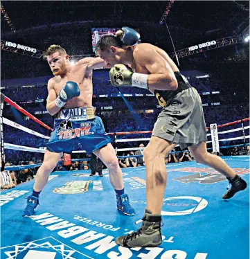  ??  ?? Brutal business: Saul “Canelo” Alvarez (left) and Gennady Golovkin trade blows during their controvers­ial draw in Las Vegas last year