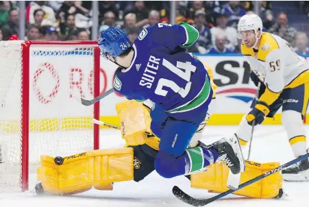  ?? DARRYL DYCK, THE CANADIAN PRESS ?? Canucks forward Pius Suter is stopped in close by Predators goalie Juuse Saros during the first period of Game 2 in Vancouver on Tuesday.